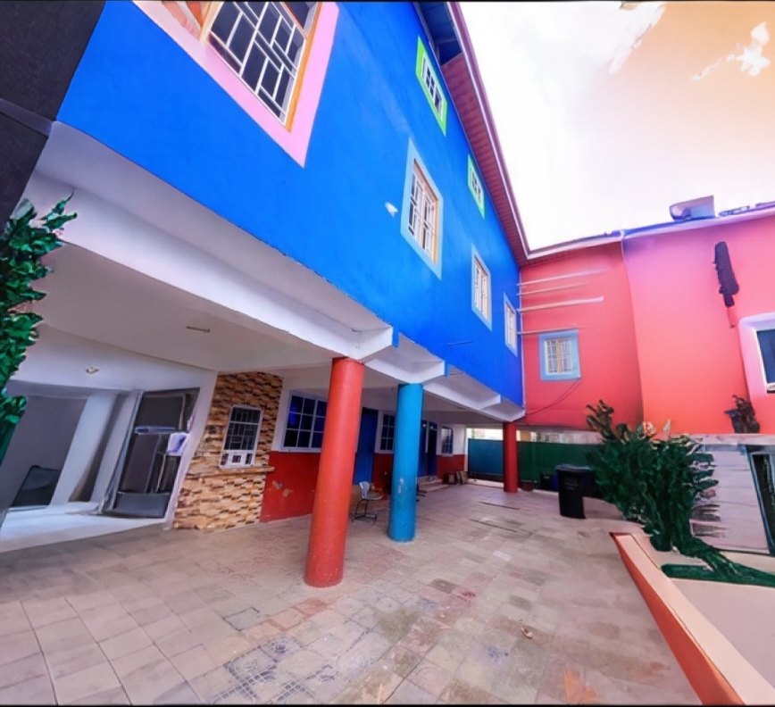 Open tiled courtyard and colourful classroom block at Humble Dream Montessori School
