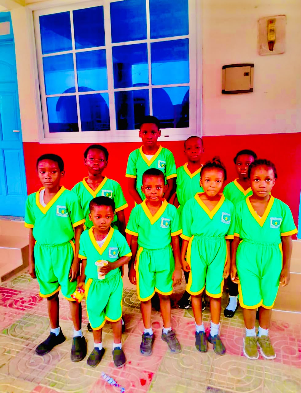 Young pupils in green and yellow school uniforms at Humble Dream Montessori School
